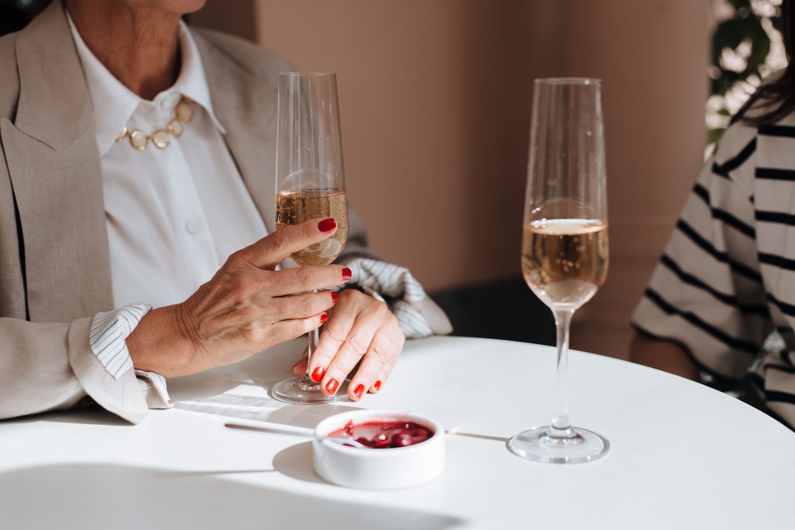 Two guests enjoying sparkling wine together at a table